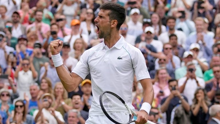 Serbia's Novak Djokovic celebrates after beating Italy's Jannik Sinner in a men's singles quarterfinal match on day nine of the Wimbledon tennis championships in London, Tuesday, July 5, 2022. (Alastair Grant/AP)