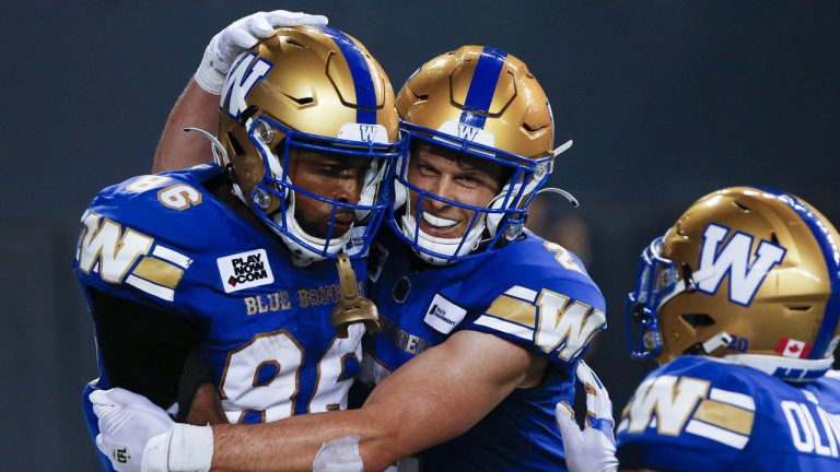 Winnipeg Blue Bombers' Carlton Agudosi (86) and Greg Ellingson (2) celebrate Agudosi’s game winning touchdown against the Calgary Stampeders during the second half of CFL action in Winnipeg, Friday, July 15, 2022. Ellingson, Edmonton receiver Kenny Lawler and Hamilton quarterback Dane Evans have been named the top performers for Week 6 of the 2022 CFL season. (John Woods/CP)