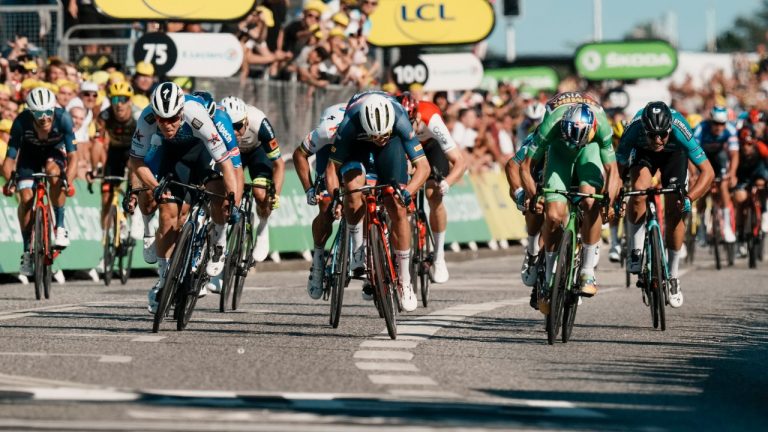 Stage winner Netherlands' Fabio Jakobsen, left, crosses the finish line ahead of second place and new overall leader Belgium's Wout Van Aert, wearing the best sprinter's green jersey, right, and third place, Denmark's Mads Pedersen, centre, in the second stage of the Tour de France cycling race over 202.5 kilometres (125.8 miles) with start in Roskilde and finish in Nyborg, Denmark, Saturday, July 2, 2022. (Thibault Camus/AP)