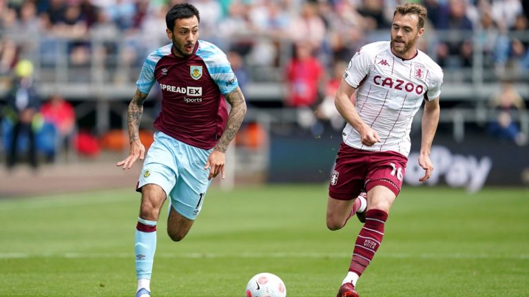Burnley's Dwight McNeil, left, and Aston Villa's Calum Chambers battle for the ball during the English Premier League soccer match between Burnley and Aston Villa at Turf Moor, Burnley, England, Saturday, May 7, 2022. (Nick Potts/PA via AP)