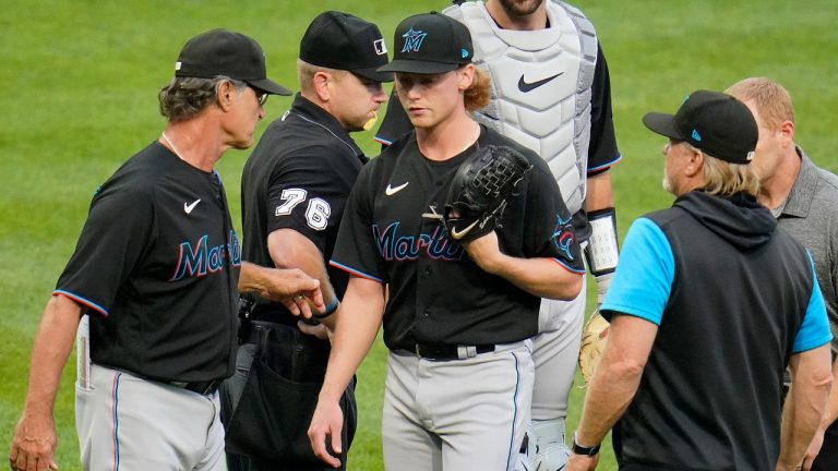 Miami Marlins starting pitcher Max Meyer, center, walks off the mound past manager Don Mattingly, left, with an unknown injury, during the first inning of a baseball game against the Pittsburgh Pirates in Pittsburgh, Saturday, July 23, 2022. (Gene J. Puskar/AP)