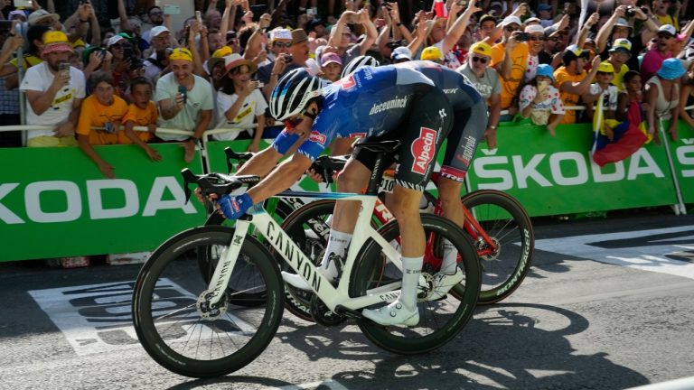 Stage winner Belgium's Jasper Philipsen, front, cross the finish line ahead of third place Denmark's Mads Pedersen, half hidden, in the fifteenth stage of the Tour de France cycling race over 202.5 kilometers (125.5 miles) with start in Rodez and finish in Carcassonne, France, Sunday, July 17, 2022. (Thibault Camus/AP)