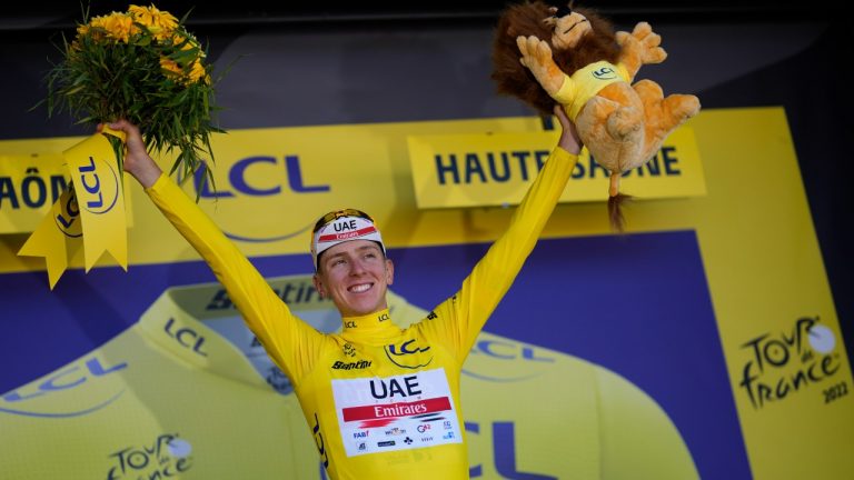 Slovenia's Tadej Pogacar, wearing the overall leader's yellow jersey, celebrates on the podium after winning the seventh stage of the Tour de France cycling race over 176.5 kilometers (109.7 miles) with start Tomblaine and finish in La Super Planche des Belles Filles, France, Friday, July 8, 2022. (Thibault Camus/AP)