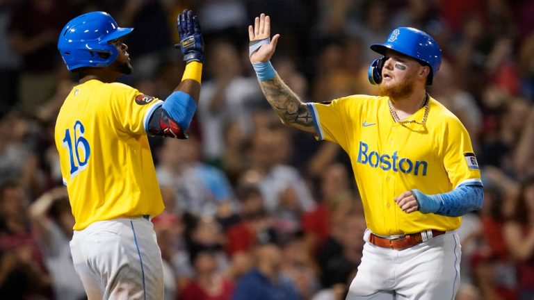 Boston Red Sox's Alex Verdugo, right, celebrates with Franchy Cordero (16) after scoring on an RBI-single by Christian Vazquez during the sixth inning of a baseball game against the Cleveland Guardians at Fenway Park, Monday, July 25, 2022, in Boston. (Charles Krupa/AP)