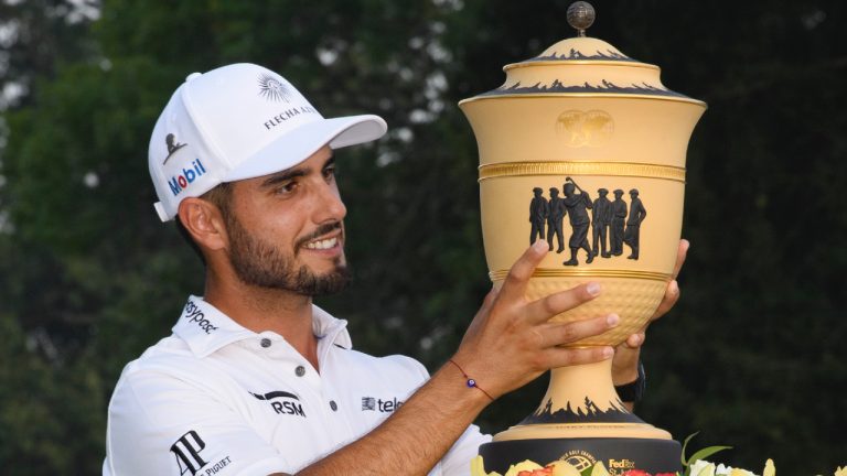 Abraham Ancer lifts the trophy after winning the World Golf Championship-FedEx St. Jude Invitational tournament, Sunday, Aug. 8, 2021, in Memphis, Tenn. (John Amis/AP)