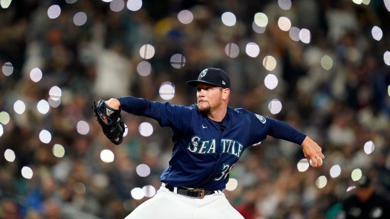 Cell phones lights are seen in the background as Seattle Mariners relief pitcher Anthony Misiewicz throws against the Los Angeles Angels in the seventh inning of a baseball game Saturday, Oct. 2, 2021, in Seattle. (Elaine Thompson/AP)