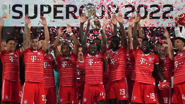 Bayern's Sadio Mane, front center, lifts the trophy as he and his teammates celebrate winning the German Supercup 2022 soccer match between German soccer cup winner RB Leipzig and German Bundesliga soccer champion FC Bayern Munich in Leipzig, Germany, Saturday, July 30, 2022. (Michael Sohn/AP)