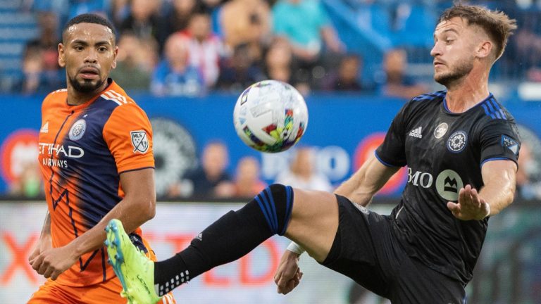 CF Montreal's Djordje Mihailovic (8) lunges for the ball as New York City FC's Alexander Callens moves in during first half MLS soccer action in Montreal, Saturday, July 30, 2022. (Graham Hughes/CP)