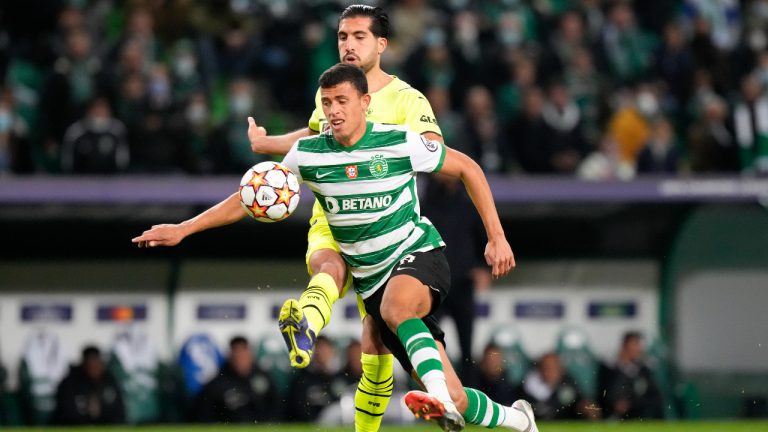 Sporting's Matheus Nunes and Dortmund's Emre Can, back, battle for the ball during a Champions League Group C soccer match between Sporting CP and Borussia Dortmund at the Alvalade stadium in Lisbon, Portugal, Wednesday, Nov. 24, 2021. (AP Photo/Armando Franca)