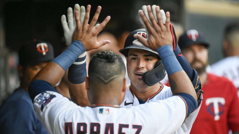 Minnesota Twins' Jose Miranda, right, celebrates with Luis Arraez after hitting a home run against the Texas Rangers during the first inning of a baseball game Friday, Aug. 19, 2022, in Minneapolis. (AP Photo/Craig Lassig)