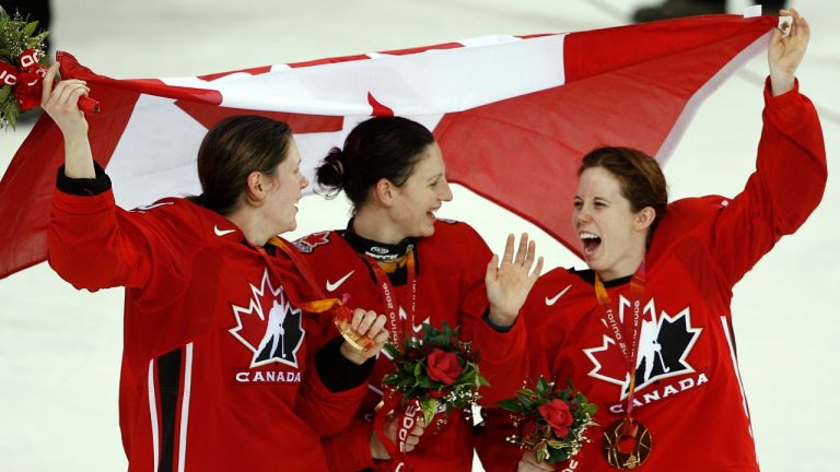Canada's Gillian Apps, Gillian Ferrari and Carla MacLeod, left ro right, celebrate their 4-1 victory over Team Sweden to win the gold medal in womens hockey at the Turin 2006 Winter Olympic Games Monday, Feb. 20, 2006 in Turin. (CP PHOTO/Paul Chiasson)