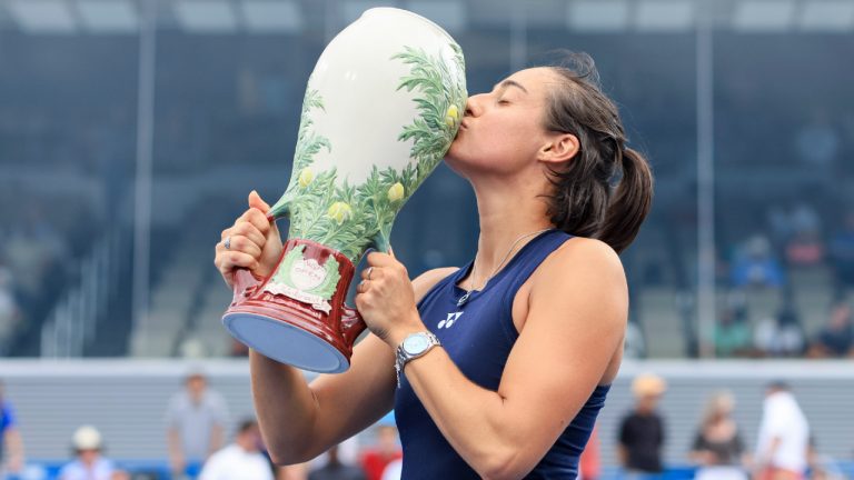 Caroline Garcia, of France, kisses the Rookwood Cup as she poses for photos after defeating Petra Kvitova, of the Czech Republic, during the women's singles final of the Western & Southern Open tennis tournament, Sunday, Aug. 21, 2022, in Mason, Ohio. (Aaron Doster/AP)