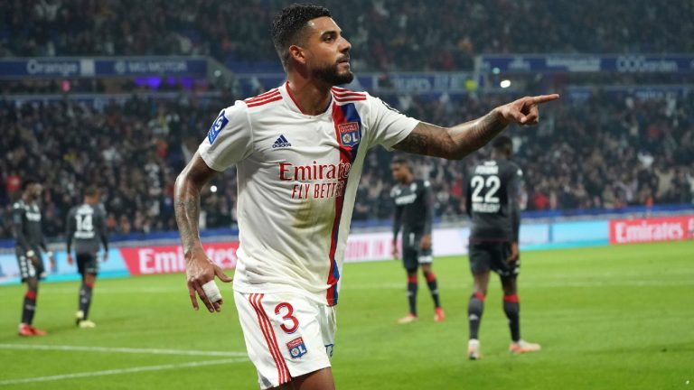 Emerson Palmieri celebrates after his teammate Jason Denayer scored against Monaco during the French League One soccer match between Lyon and Monaco at the Groupama stadium in Lyon, France, Saturday, Oct. 16, 2021. (Laurent Cipriani/AP)