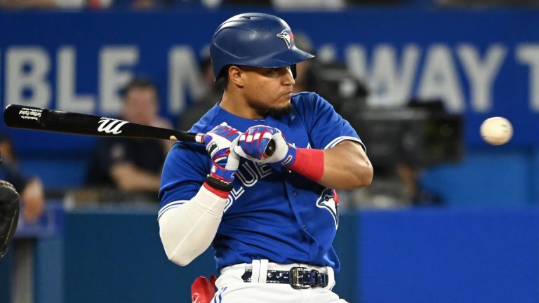 Toronto Blue Jays second baseman Satiago Espinal ducks away from a high, inside pitch from Baltimore Orioles starting pitcher Dean Kremer in fourth inning American League baseball action in Toronto on Tuesday, August 16, 2022. (Jon Blacker/CP)