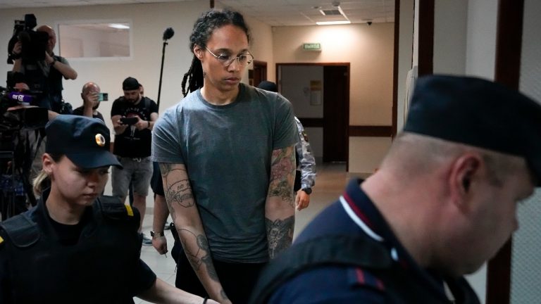 WNBA star and two-time Olympic gold medalist Brittney Griner, center, is escorted in a court room prior to a hearing, in Khimki just outside Moscow, Russia, Thursday, Aug. 4, 2022. Closing arguments in Brittney Griner's cannabis possession case are set for Thursday, nearly six months after the American basketball star was arrested at a Moscow airport in a case that reached the highest levels of US-Russia diplomacy. (Alexander Zemlianichenko/AP Photo)