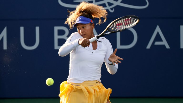 Naomi Osaka, of Japan, follows through on a return to Coco Gauff, of the United States, at the Mubadala Silicon Valley Classic tennis tournament Thursday, Aug. 4, 2022, in San Jose, Calif. (Santiago Mejia/San Francisco Chronicle via AP)