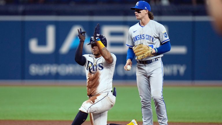Tampa Bay Rays' Harold Ramirez reacts after hitting a double off Kansas City Royals starting pitcher Brady Singer during the sixth inning of a baseball game Friday, Aug. 19, 2022, in St. Petersburg, Fla. Late with the tag is shortstop Bobby Witt Jr. (7). (Chris O'Meara/AP)