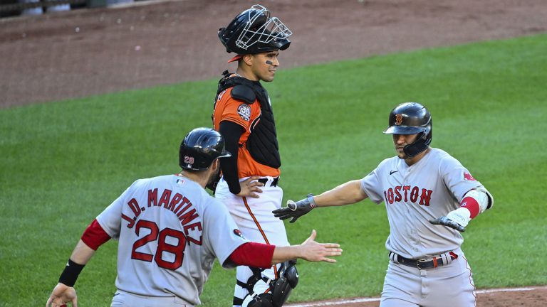 Boston Red Sox's Enrique Hernandez, right, is greeted by J.D. Martinez (28) after hitting a two-run home run that also scored Martinez against Baltimore Orioles starting pitcher Kyle Bradish during the sixth inning of a baseball game, Saturday, Aug 20, 2022, in Baltimore. (Terrance Williams/AP)