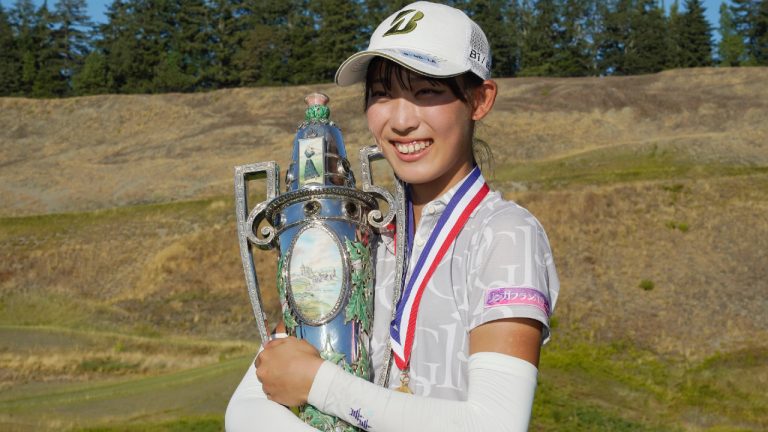Saki Baba, of Japan, poses for photos with the trophy after she won the USGA Women's Amateur Golf Championship, Sunday, Aug. 14, 2022, at Chambers Bay in University Place, Wash. (Ted S. Warren/AP)