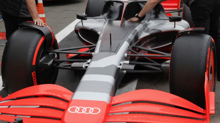 Crew move into position the new Audi F1 car during a media conference ahead of the Formula One Grand Prix at the Spa-Francorchamps racetrack in Spa, Belgium, Friday, Aug. 26, 2022. (Olivier Matthys/AP) 