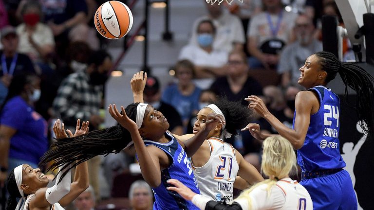 Connecticut Sun forward Jonquel Jones (35) looks for a rebound between Phoenix Mercury players during a WNBA basketball game Thursday, Aug. 4, 2022, in Uncasville, Conn. (Sarah Gordon/The Day via AP)