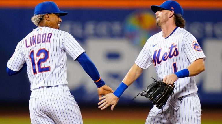 New York Mets' Francisco Lindor (12) celebrates with Jeff McNeil (1) after the team's baseball game against the Cincinnati Reds on Tuesday, Aug. 9, 2022, in New York. The Mets won 6-2. (Frank Franklin II/CP)