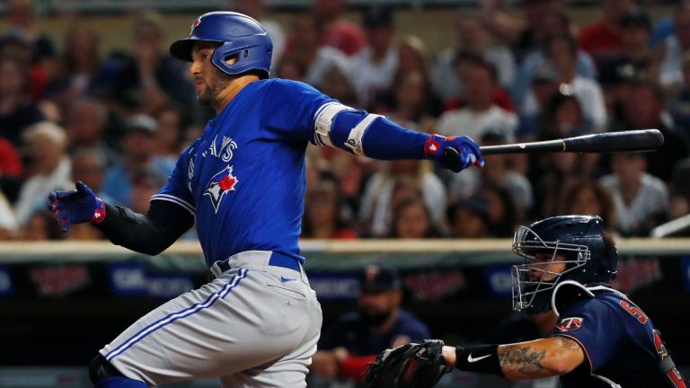 Toronto Blue Jays' George Springer watches his two-run single against the Minnesota Twins during the eighth inning of a baseball game Thursday, Aug. 4, 2022, in Minneapolis. (Bruce Kluckhohn/AP)