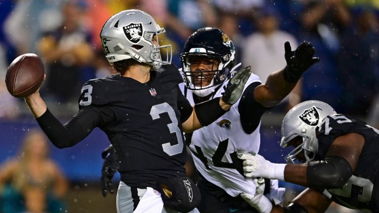 Las Vegas Raiders quarterback Jarrett Stidham (3) throws a pass under pressure from Jacksonville Jaguars linebacker Travon Walker (44) during the first half of the NFL football Hall of Fame Game exhibition Thursday, Aug. 4, 2022, in Canton, Ohio. (David Dermer/AP)