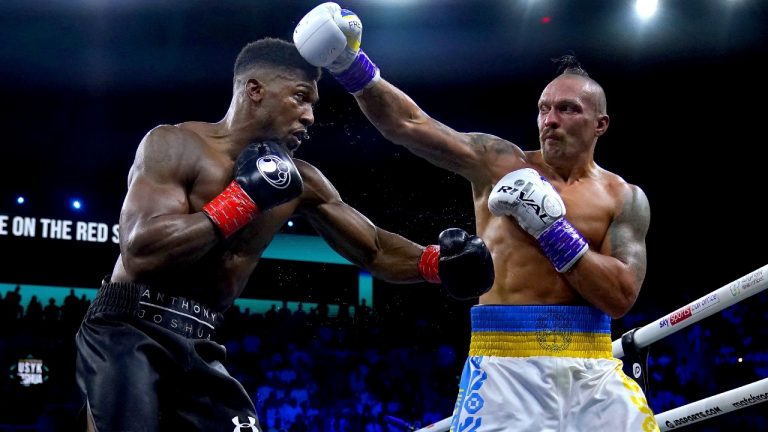 Britain's Anthony Joshua and Ukraine's Oleksandr Usyk exchange punches during their world heavyweight title fight at King Abdullah Sports City in Jeddah, Saudi Arabia, Sunday, Aug. 21, 2022. (Nick Potts/PA via AP)