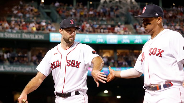 Boston Red Sox pitcher Michael Wacha, left, congratulates teammate Rafael Devers, right, as they walk off the field after Devers made a diving stop against the New York Yankees to save a run during the fifth inning of a baseball game at Fenway Park. (Paul Connors/AP)