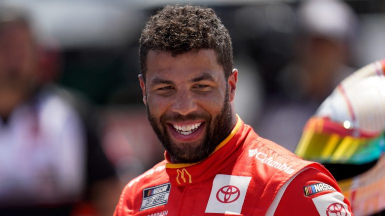 Bubba Wallace smiles during NASCAR Cup Series auto race qualifying at the Michigan International Speedway in Brooklyn, Mich., Saturday, Aug. 6, 2022. Wallace won the pole position. (Paul Sancya/AP)