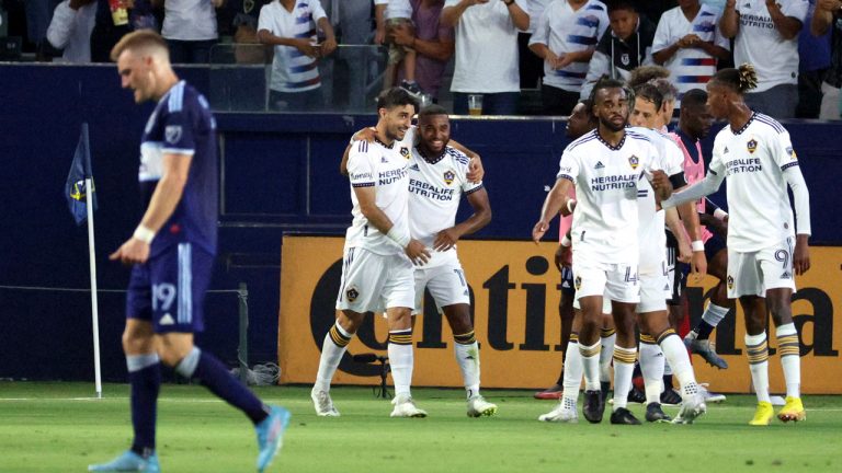 LA Galaxy midfielder Samuel Grandsir, second from left in back, celebrates with midfielder GastÃ³n Brugman, left, after Grandsir scored a goal against the Vancouver Whitecaps during the first half of an MLS soccer match. (Raul Romero Jr./AP)