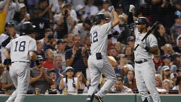 New York Yankees' Isiah Kiner-Falefa (12) celebrates with Aaron Hicks after hitting a two-run home run that scored Andrew Benintendi (18) during the fifth inning of the team's baseball game against the Boston Red Sox. (Michael Dwyer/AP)