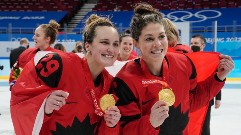 Team Canada's Marie-Philip Poulin (29) and forward Rebecca Johnston (6) celebrate with their gold medals after defeating the United States in women's hockey gold medal game action at the 2022 Winter Olympics. (Ryan Remiorz/CP)
