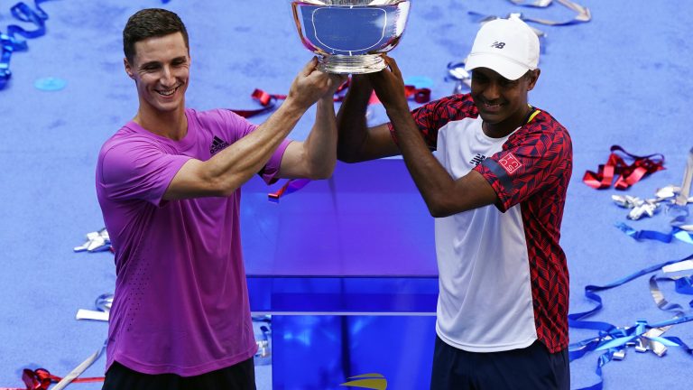Rajeev Ram, of the United States, right, and Joe Salisbury, of Britain, celebrate with the trophy after defeating Wesley Koolhof, of the Netherlands, and Neal Skupski, of Britain, in the final of the men's doubles at the the U.S. Open tennis championships, Friday, Sept. 9, 2022, in New York. (Matt Rourke/AP)