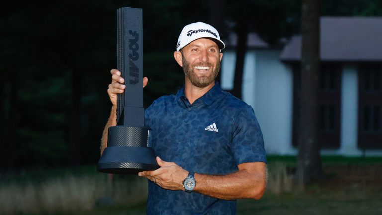 Dustin Johnson celebrates with the trophy after winning the LIV Golf Invitational-Boston tournament in a playoff Sunday, Sept. 4, 2022, in Bolton, Mass. (Mary Schwalm/AP)