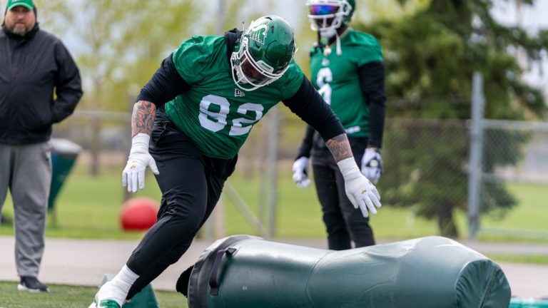 Saskatchewan Roughriders defensive lineman Garrett Marino (92) knocks down a dummy during the first day of the team’s training camp at Griffiths Stadium in Saskatoon, Sask., on Friday, May 20, 2022. (Heywood Yu/The Canadian Press)
