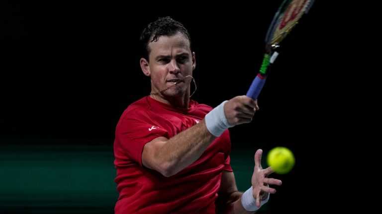 Canada's Vasek Pospisil returns the ball to Kazakhstan's Alexander Bublik during their Davis Cup tennis match at Madrid Arena in Madrid, Spain, Sunday, Nov. 28, 2021. (Bernat Armangue/AP Photo)