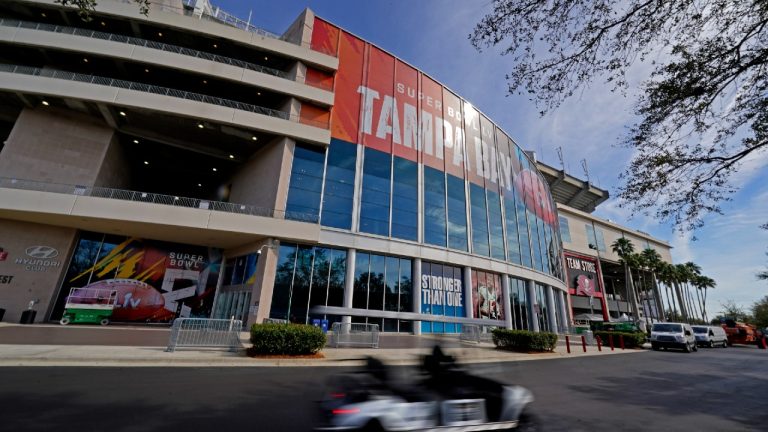 Workers drive past Raymond James Stadium ahead of Super Bowl 55 Thursday, Feb. 4, 2021, in Tampa, Fla. The city is hosting Sunday's Super Bowl football game between the Tampa Bay Buccaneers and the Kansas City Chiefs. (Charlie Riedel/AP)