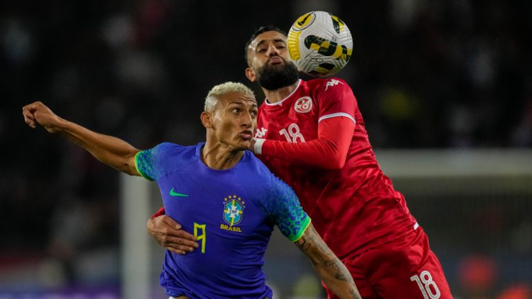 Tunisia's Ghaylen Chaaleli, right, duels for the ball with Brazil's Richarlison during the international friendly soccer match between Brazil and Tunisia at the Parc des Princes stadium in Paris, France, Tuesday, Sept. 27, 2022. (Christophe Ena/AP) 