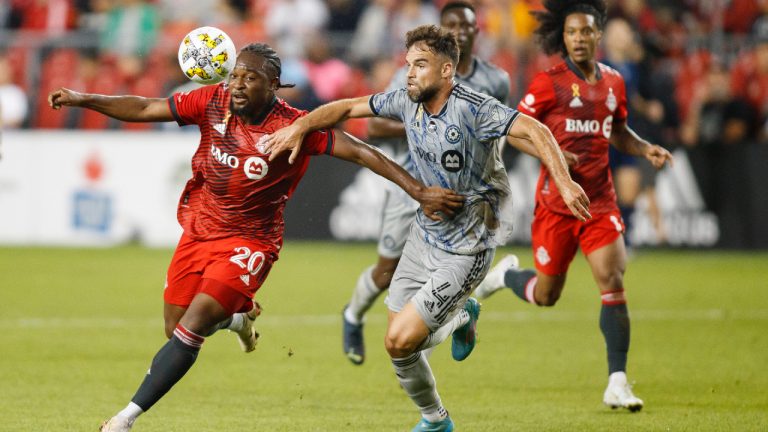 Toronto FC forward Ayo Akinola (20) and CF Montreal defender Rudy Camacho (4) battle of the ball during first half MLS soccer action in Toronto on Sunday, Sept. 4, 2022. (Cole Burston/CP)