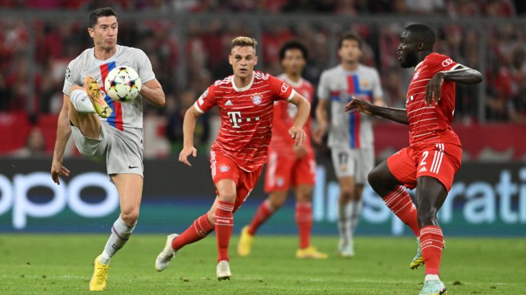 Barcelona's Robert Lewandowski, left, Bayern's Joshua Kimmich, centre, Bayern's Dayot Upamecano, right, in action during the Champions League, group C soccer match between Bayern Munich and Barcelona at the Allianz Arena in Munich, Germany, Tuesday, Sept. 13, 2022. (Andreas Schaad/AP)