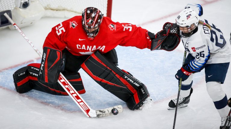 Canada's goalie Ann-Renee Desbiens, left, blocks a shot from Kendall Coyne Schofield, of the United States, during third period gold medal final IIHF Women's World Championship hockey action in Calgary, Tuesday, Aug. 31, 2021. (Jeff McIntosh/CP)