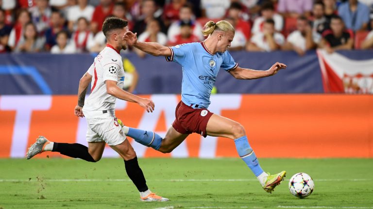 Manchester City's Erling Haaland, right, attempts a shot during the group G Champions League soccer match between Sevilla and Manchester City in Seville, Spain, Tuesday, Sept. 6, 2022. (Jose Breton/AP)
