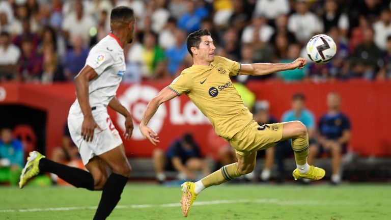 Barcelona's Robert Lewandowski jumps to attempt a shot during the Spanish La Liga soccer match between Sevilla and Barcelona in Seville, Spain, Saturday, Sept. 3, 2022. (Jose Breton/AP)