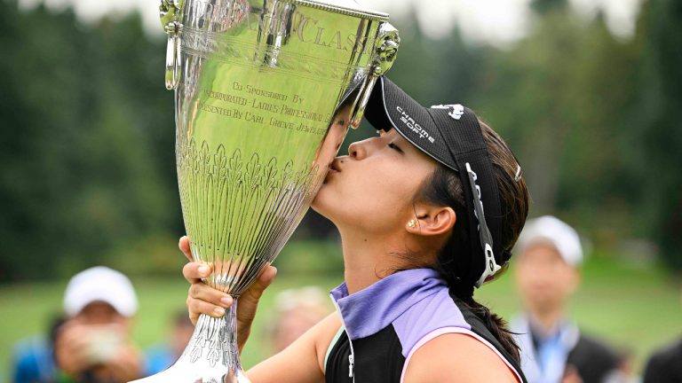 Andrea Lee, of the United States, kisses the champion's trophy after winning the LPGA Portland Classic golf tournament in Portland, Ore., Sunday, Sept. 18, 2022. (Troy Wayrynen/AP)