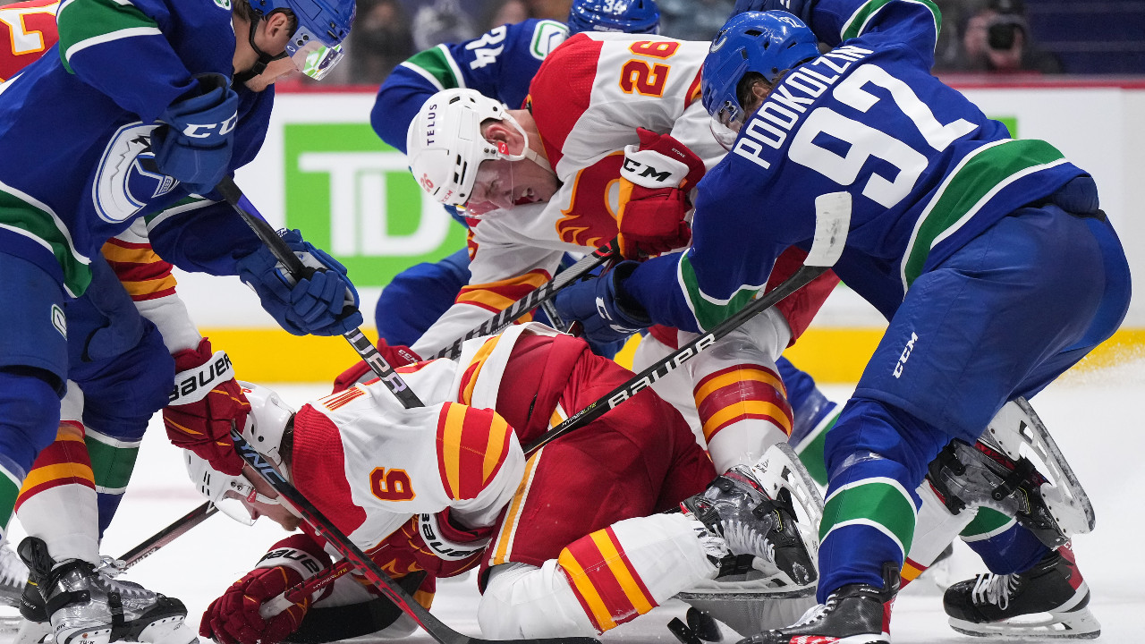 Stone scores in OT as Flames defeat Canucks in overtime in split-squad game