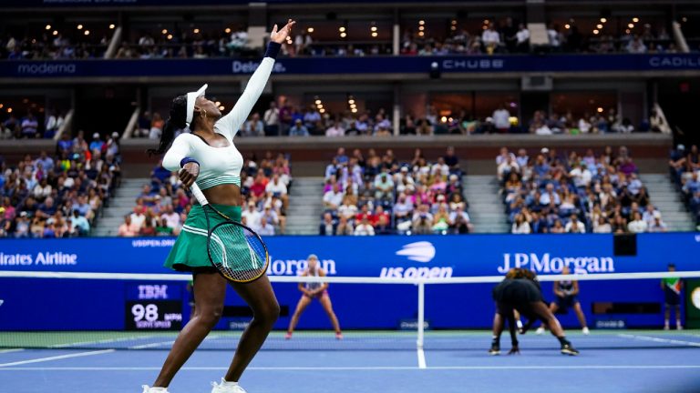 Venus Williams, accompanied by Serena Williams, of the United States, serves during their first-round doubles match against Lucie Hradecká and Linda Nosková, of Czechia, at the U.S. Open tennis championships, Thursday, Sept. 1, 2022, in New York. (AP)