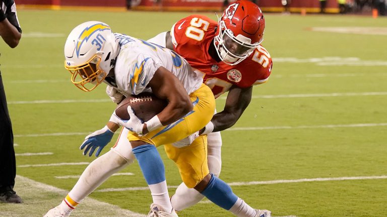 Kansas City Chiefs linebacker Willie Gay (50) tackles Los Angeles Chargers running back Austin Ekeler (30) during the second half of an NFL football game Thursday, Sept. 15, 2022, in Kansas City, Mo. (Charlie Riedel/AP) 