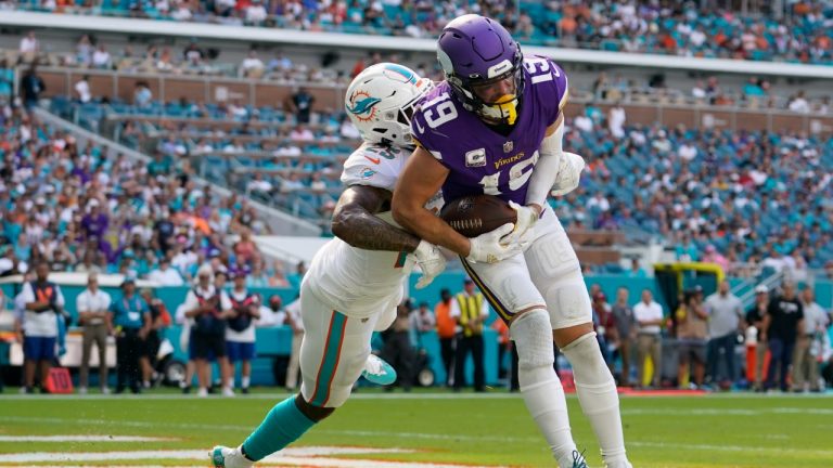 Minnesota Vikings wide receiver Adam Thielen (19) scores a touchdown under pressure from Miami Dolphins cornerback Xavien Howard (25), during the second half of an NFL football game, Sunday, Oct. 16, 2022, in Miami Gardens, Fla. (Lynne Sladky/AP)